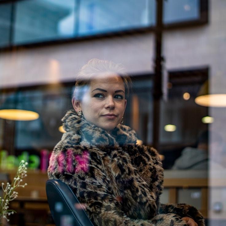 Alex Kim, Lead Design Curator at OlivePaperStudio, reviewing corporate floral arrangements